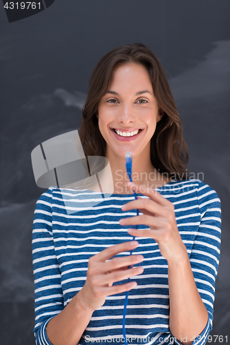 Image of woman holding a internet cable in front of chalk drawing board