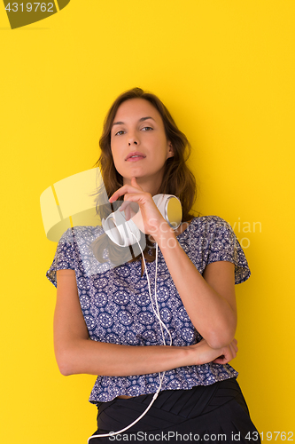 Image of woman with headphones isolated on a yellow