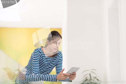 Image of young woman at home websurfing