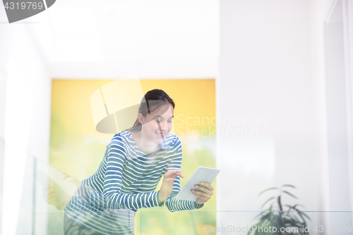 Image of young woman at home websurfing