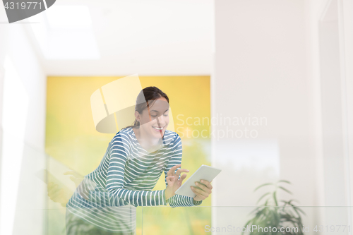 Image of young woman at home websurfing