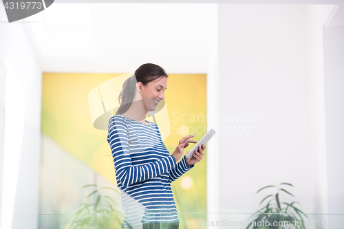 Image of young woman at home websurfing