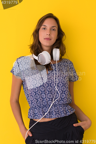 Image of woman with headphones isolated on a yellow