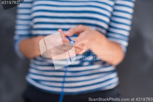 Image of woman holding a internet cable in front of chalk drawing board