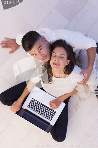 Image of couple using tablet and laptop computers top view