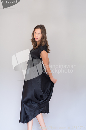 Image of woman in a black dress isolated on white background