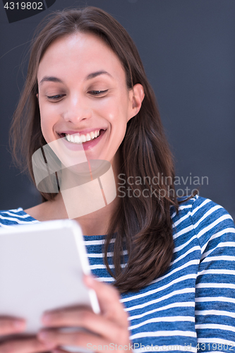 Image of woman using tablet  in front of chalk drawing board