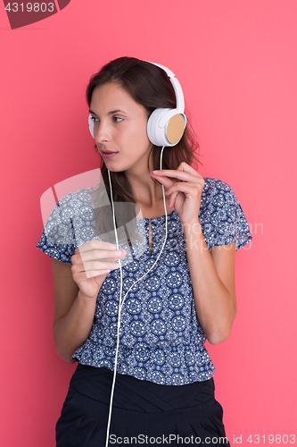 Image of woman with headphones isolated on a red