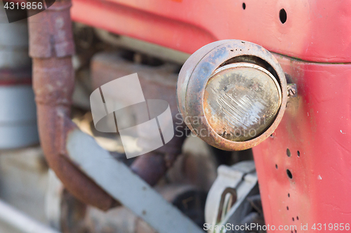 Image of Old tractor face, selective focus on it\'s light