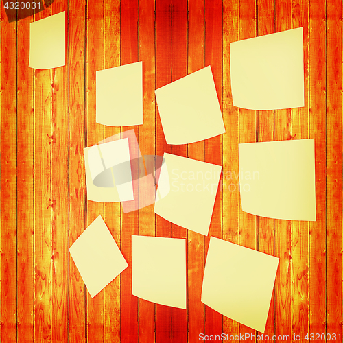 Image of Mock-up of Sticky note paper on a wooden wall. 3D illustration. 