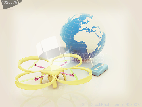 Image of Quadrocopter Drone with Earth Globe and remote controller on a w