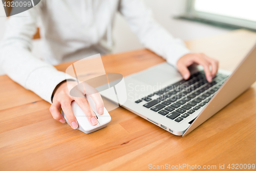 Image of Woman using notebook computer at home