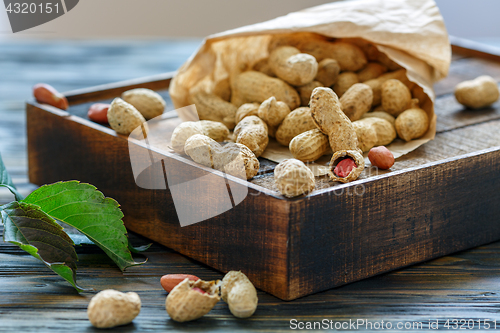 Image of Unshelled peanuts in a paper bag.