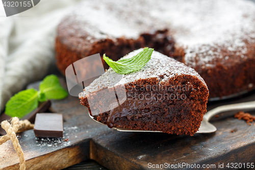 Image of Piece of chocolate cake dusted with powdered sugar.
