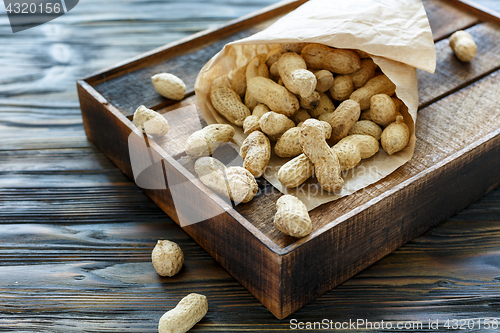 Image of Paper bag with unshelled peanuts.