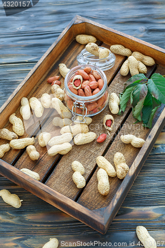 Image of Glass jar with peeled peanuts.