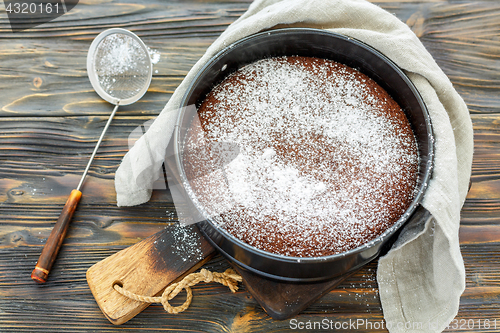 Image of Chocolate cake sprinkled with powdered sugar.