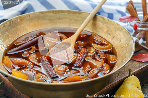Image of Jam from pears with cinnamon in a copper basin.