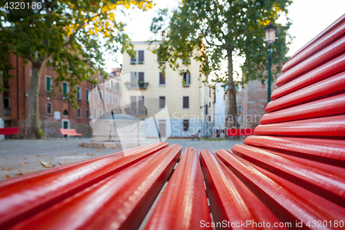 Image of Venice from a red bench