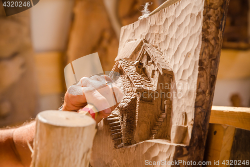 Image of Sculptor hands working wood