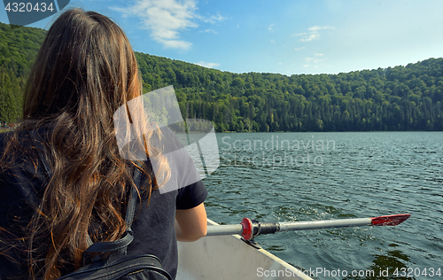 Image of Girl back view sailing on lake