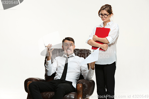 Image of The young man and beautiful woman in business suit at office on white background