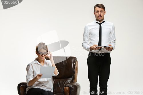 Image of The young man and beautiful woman in business suit at office on white background