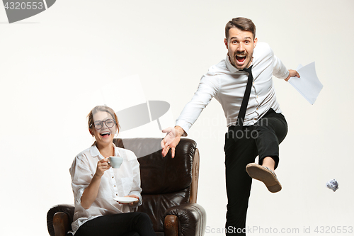 Image of The young man and beautiful woman in business suit at office on white background