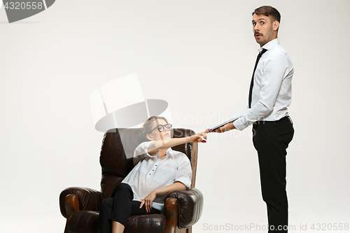 Image of The young man and beautiful woman in business suit at office on white background