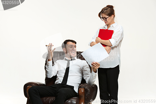 Image of The young man and beautiful woman in business suit at office on white background