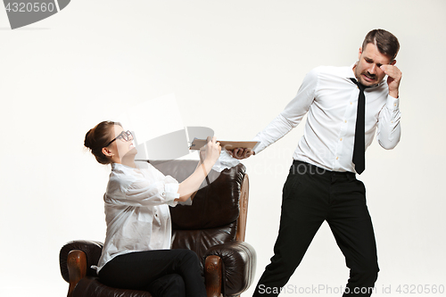 Image of The young man and beautiful woman in business suit at office on white background