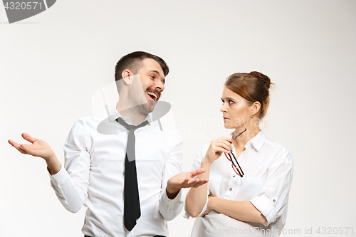 Image of The business man and woman communicating on a gray background