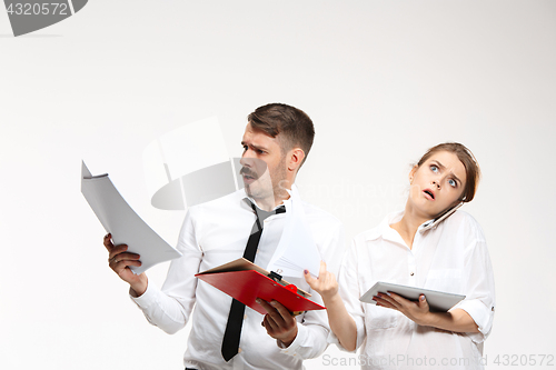 Image of The business man and woman communicating on a gray background