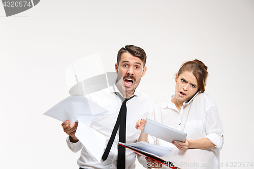 Image of The business man and woman communicating on a gray background