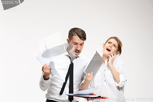 Image of The business man and woman communicating on a gray background