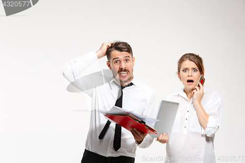 Image of The business man and woman communicating on a gray background