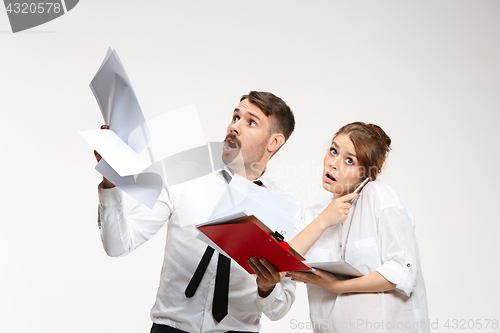 Image of The business man and woman communicating on a gray background