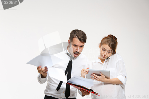 Image of The business man and woman communicating on a gray background