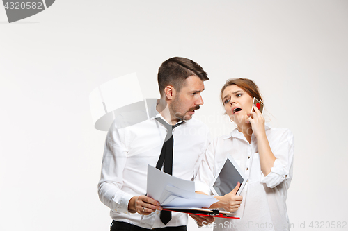 Image of The business man and woman communicating on a gray background