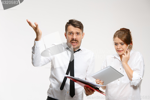 Image of The business man and woman communicating on a gray background