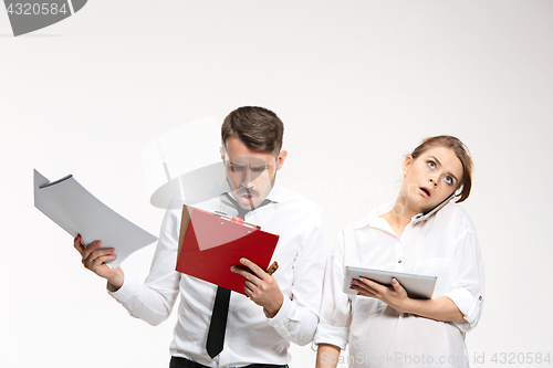 Image of The business man and woman communicating on a gray background