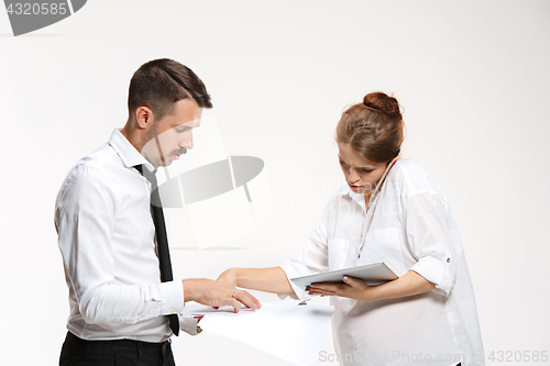 Image of The business man and woman communicating on a gray background