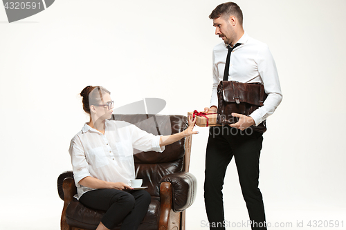 Image of The young man and beautiful woman in business suit at office on white background