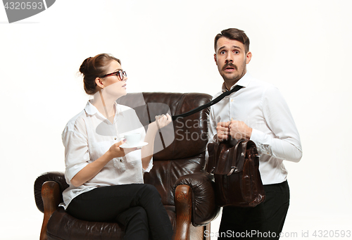 Image of The young man and beautiful woman in business suit at office on white background