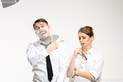 Image of The young man and beautiful woman in business suit at office on white background