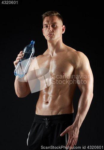 Image of young man or bodybuilder with bottle of water