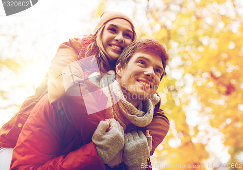 Image of happy young couple having fun in autumn park