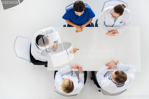 Image of doctor showing something imaginary on table