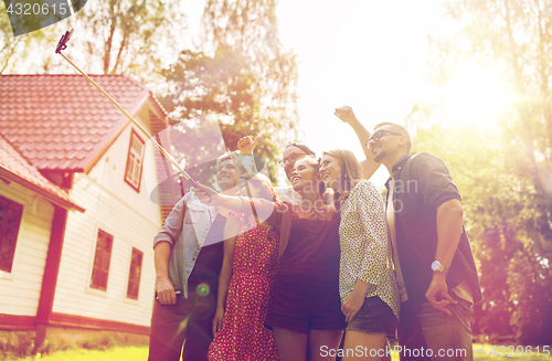 Image of friends taking selfie at party in summer garden