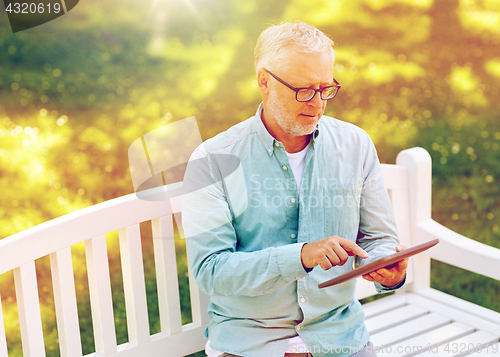 Image of senior man with tablet pc at summer park